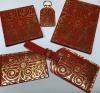 <span style="font-size: small;">A range of red and gold leather accessories. The design is based on the pattern on the&nbsp;Gilebertus doors.</span><br /><span style="font-size: small;"> Made in UK.</span>